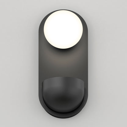 The Artika Bloomfield LED modern mid-century wall sconce 5 CCT features a round white bulb atop a curved, matte black base, wall-mounted against a plain light gray background.