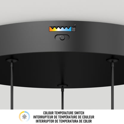 Close-up of the Elmo 5-light LED pendant by Artika, showing its black ceiling base and color temperature switch with a range of options. The label below reads COLOUR TEMPERATURE SWITCH in English and French.