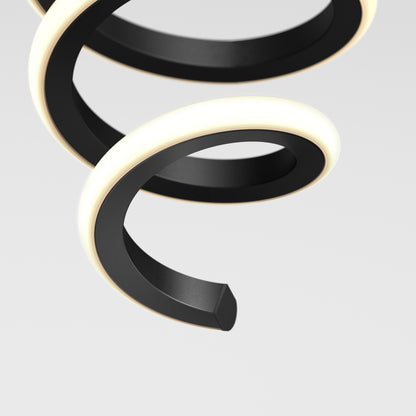 A close-up of the Artika Chorus 1-light LED pendant 5 CCT, a modern black spiral fixture with a glowing white edge, set against a plain light gray background.