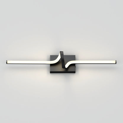 The Artika Bowtie modern LED bathroom vanity light features a central black square base and a sleek, zigzag horizontal light bar, adding contemporary style to a plain light grey wall.