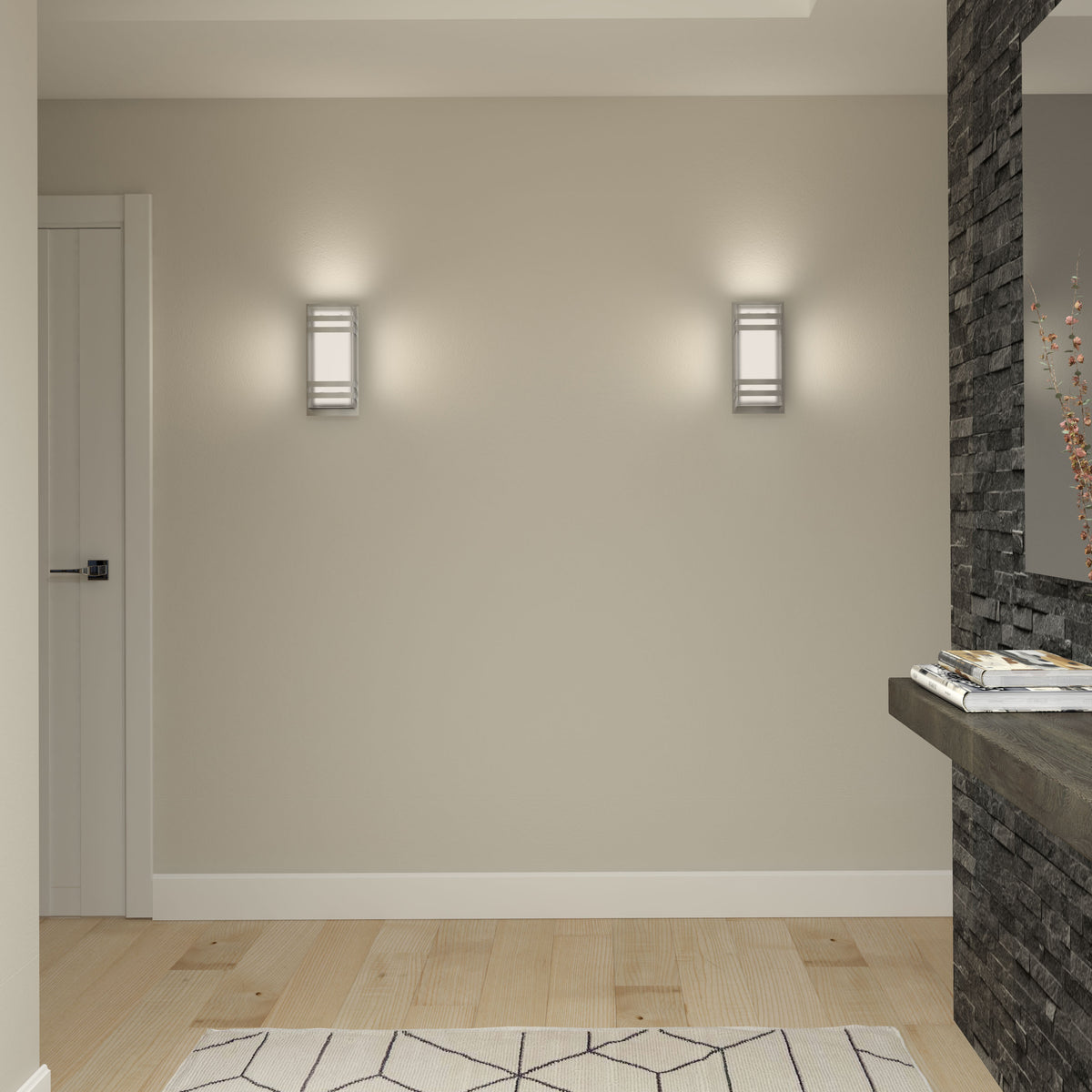 A minimalist hallway with light wood floors, a beige wall featuring two modern wall sconces, a white door on the left, a geometric rug, and a floating stone shelf with magazines and a vase.