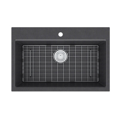 Artika Baycrest 33 in. black single bowl sink with a silver grid rack and round center drain, viewed from above.