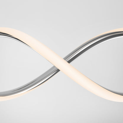 The Artika DNA Linear LED modern pendant light features a sleek, curved infinity design with a silver metallic finish and emits a soft white glow, shown against a plain light gray background.