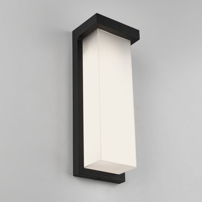 The Artika Skeet LED indoor-outdoor light features a modern rectangular frosted white shade and a sleek black frame, shown mounted on a light gray wall.