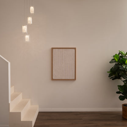 A minimal interior with white stairs, an Artika Crystal Cube 4-light LED pendant, a framed textured artwork on a beige wall, dark wood flooring, and a leafy potted plant on the right.