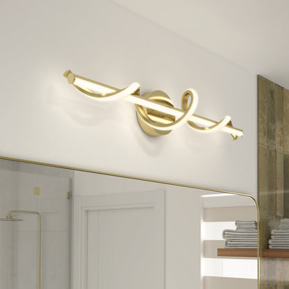 The Artika Coda modern LED bathroom vanity light 5 CCT features a brushed gold finish and looped design, making it a stylish choice for mounting above a mirror in contemporary, minimalist interiors.