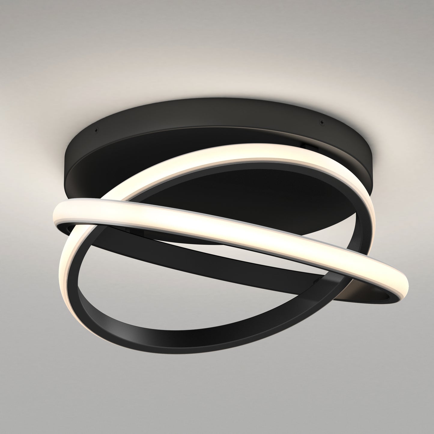 The Artika Orbia modern LED flush mount light 3 CCT features a black base with two intertwined loops—one lit, one matte black—creating an abstract, contemporary look on a plain white ceiling.