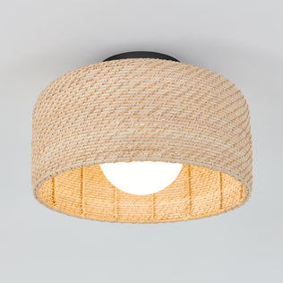 The Artika Emiko modern LED flush mount light features a round, woven rattan shade and visible glowing bulb, mounted on a white ceiling with 5 selectable color temperatures.