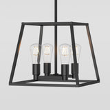 A modern black metal pendant light fixture with a geometric open frame design, featuring four exposed vintage-style Edison bulbs arranged in the center. The background is plain and light-colored.