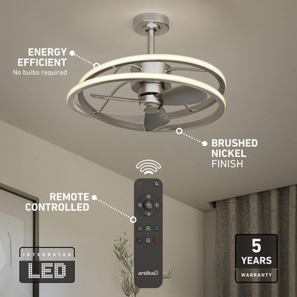 Artika Coda 23 in. LED modern ceiling fan features a brushed nickel finish, integrated LED light kit (no bulbs needed), remote control, and comes with a 5-year warranty. Remote shown in foreground. Energy efficient design.