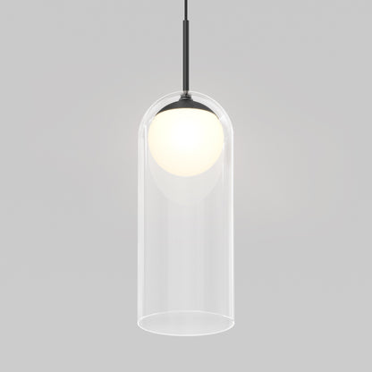 The Artika Mirah LED modern mid-century pendant light 3 CCT features a glowing white bulb in a clear cylindrical glass shade, hanging from a black cord against a plain light gray background.