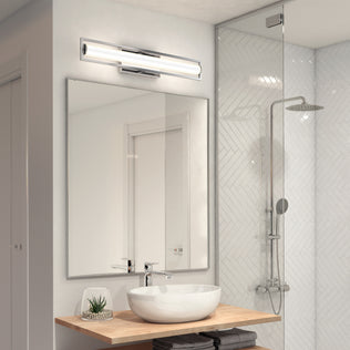 A modern bathroom with a large mirror, round vessel sink on a wooden countertop, small potted plant, glass shower with rainfall showerhead, and the Artika Rialto modern LED bathroom vanity light 3 CCT above the mirror.