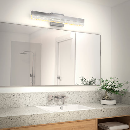 A modern bathroom features a large mirror, a rectangular sink in a speckled countertop, chrome faucet, potted plant, towels, and the Artika Essence Bubble Bar LED vanity light mounted horizontally above the mirror.
