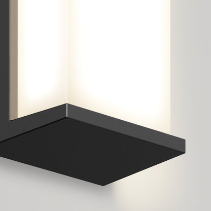 Close-up of the Artika Faro modern LED indoor-outdoor wall light 3 CCT, featuring a rectangular black metal base and frosted white glass shade softly illuminating a light-colored wall.