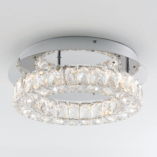 The Artika Celebrity LED flush mount light features two concentric rings of crystal-like segments on a circular chrome base, creating a bright, elegant glow against any white ceiling.