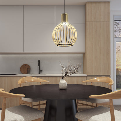 A modern kitchen with light wood cabinets, a round black table and four wooden chairs, a vase with branches, and the Artika Tomi LED Pendant Light 3 CCT stylishly hanging above. Sunlight streams in through a window on the right.