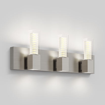 The Artika Hologram LED modern bathroom vanity light features three rectangular lights with clear glass covers and metallic bases, mounting stylishly on the wall while emitting a soft white glow.