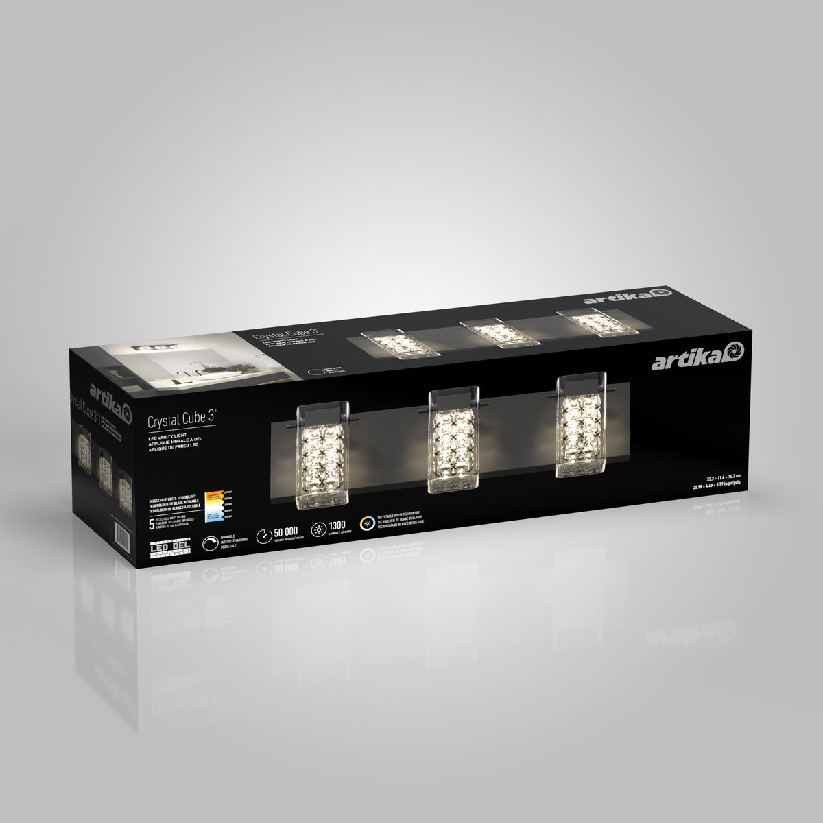 A black box for the Artika Crystal Cube 3 light fixture shows three crystal-accented lights, product info, and branding on a gray background.