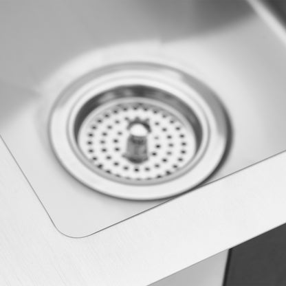 Close-up of the Artika Plaza Bar Single Bowl Sink, featuring a clean, modern stainless steel design with a central metal drain and strainer basket. The smooth, brushed surface and sleek edges are clearly visible.