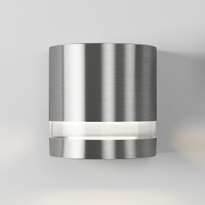 The Artika Valor Round LED wall light features a brushed metal finish and a horizontal strip near its base for modern style.