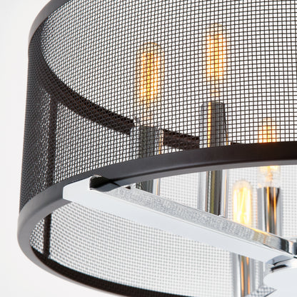 Close-up of the Artika Subway LED modern bathroom vanity light, featuring exposed bulbs, chrome supports, and a cylindrical black mesh shade with warmly glowing bulbs.