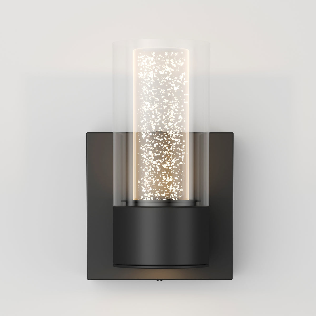 A modern wall sconce with a black square base and a cylindrical glass cover. Inside, small glowing lights create a sparkling effect, giving the fixture a contemporary and elegant appearance.