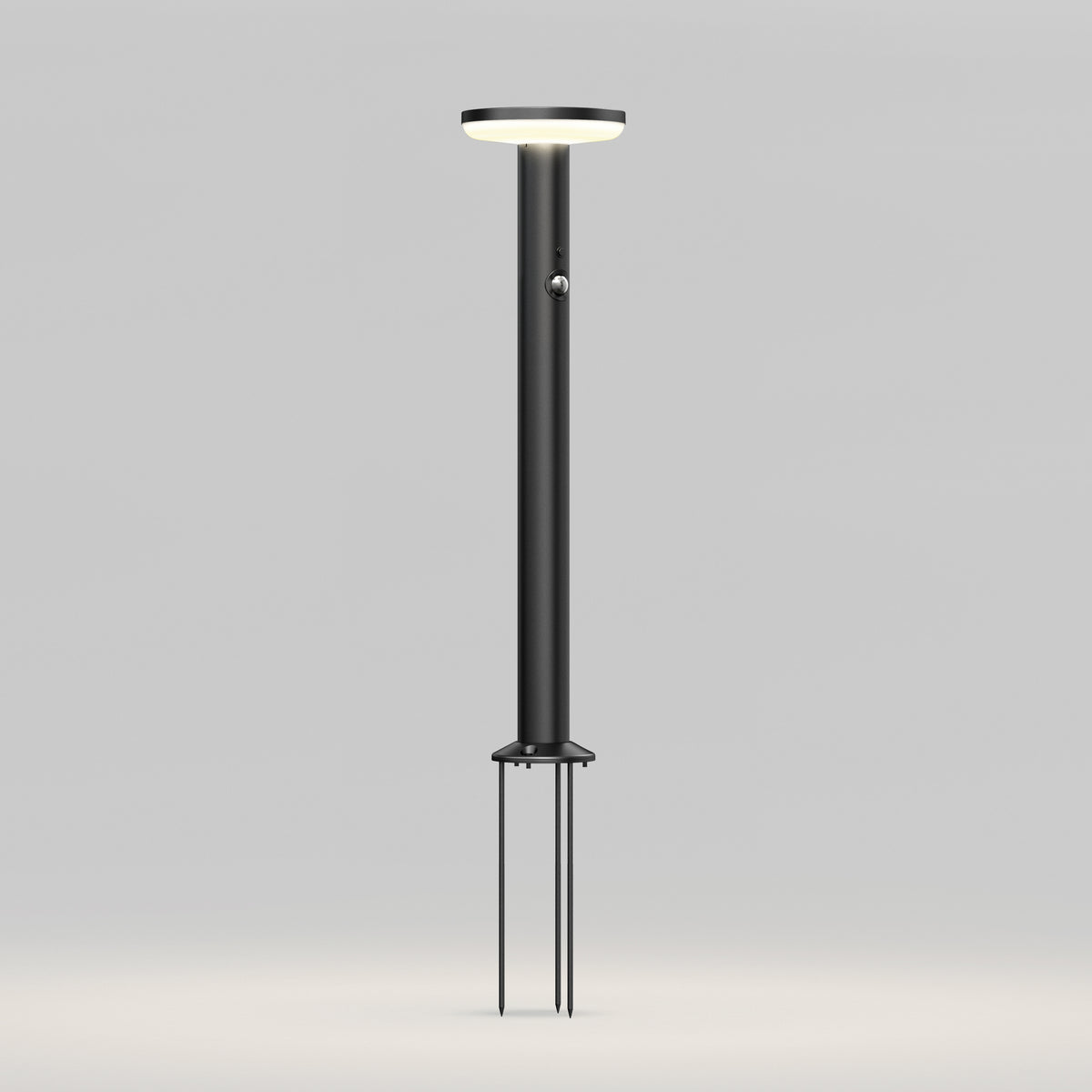 The Artika Urbia Solar LED Bollard features a modern black design with a circular top and three stakes for easy ground installation.