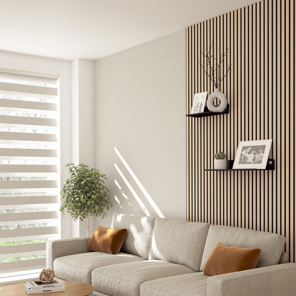 A modern living room with a beige sofa, brown cushions, a potted plant, and soundproof wall panels. Two Artika Sonokit shelves and hooks for Sonolok and Sonofold panels display framed photos. Sunlight filters through striped blinds.