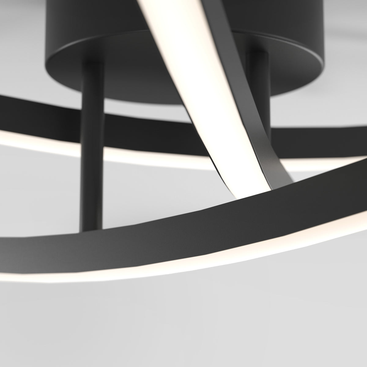 Close-up of a modern ceiling light fixture with curved, black metal arms and integrated white LED strips, set against a plain white background.