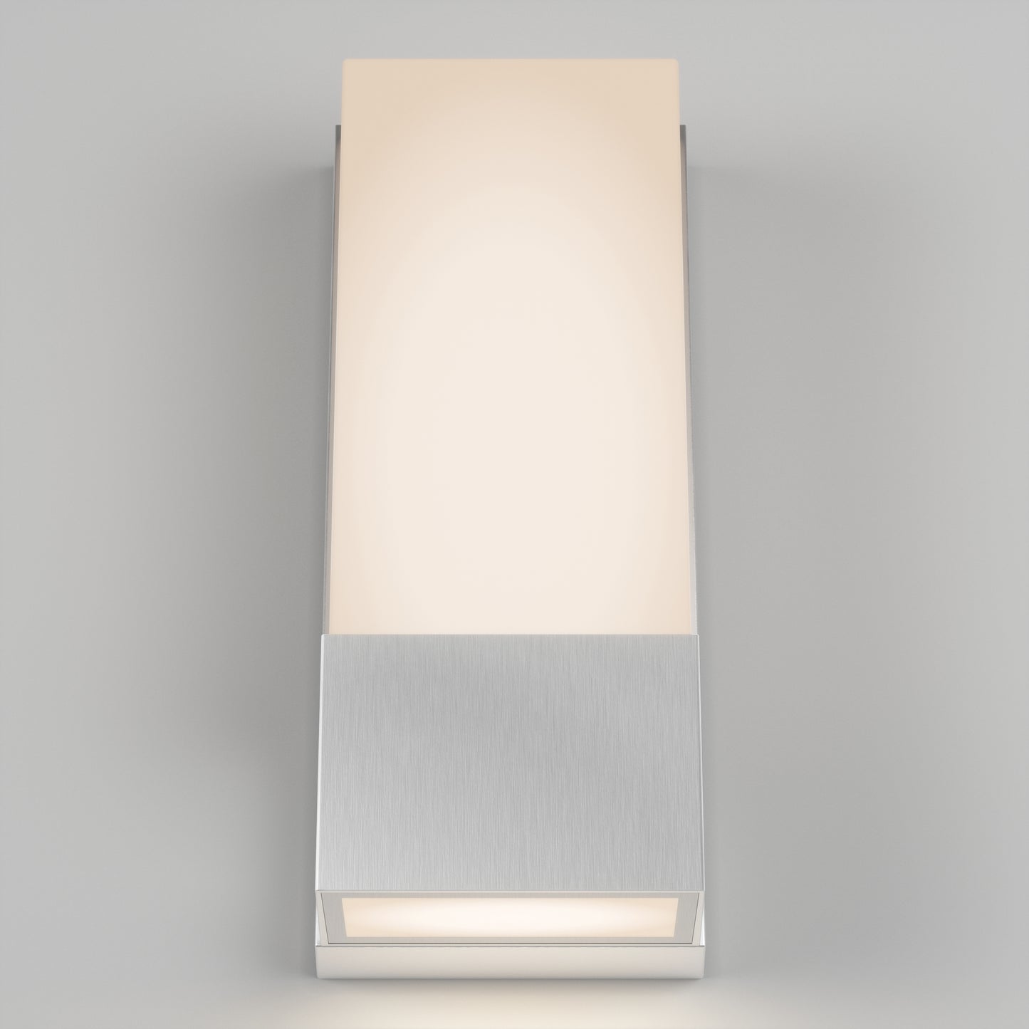 The Artika Dixon indoor-outdoor LED wall light features a brushed metal base and rectangular frosted glass shade, casting a soft, warm glow against a light gray background.