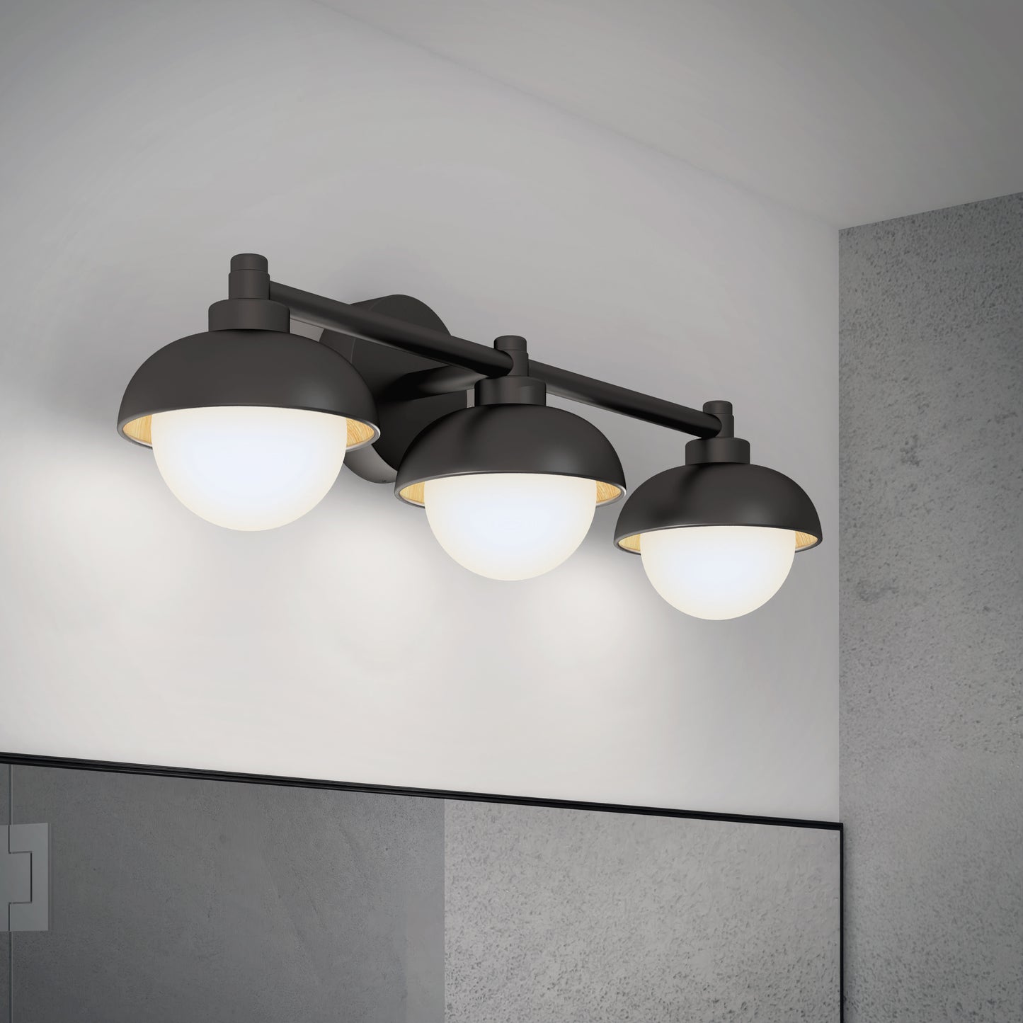 The Artika Boden LED mid-century bathroom vanity light, featuring black finish and round frosted glass shades, is mounted above a bathroom mirror on a light gray wall.
