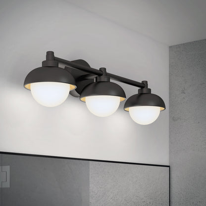 The Artika Boden LED mid-century bathroom vanity light, featuring black finish and round frosted glass shades, is mounted above a bathroom mirror on a light gray wall.