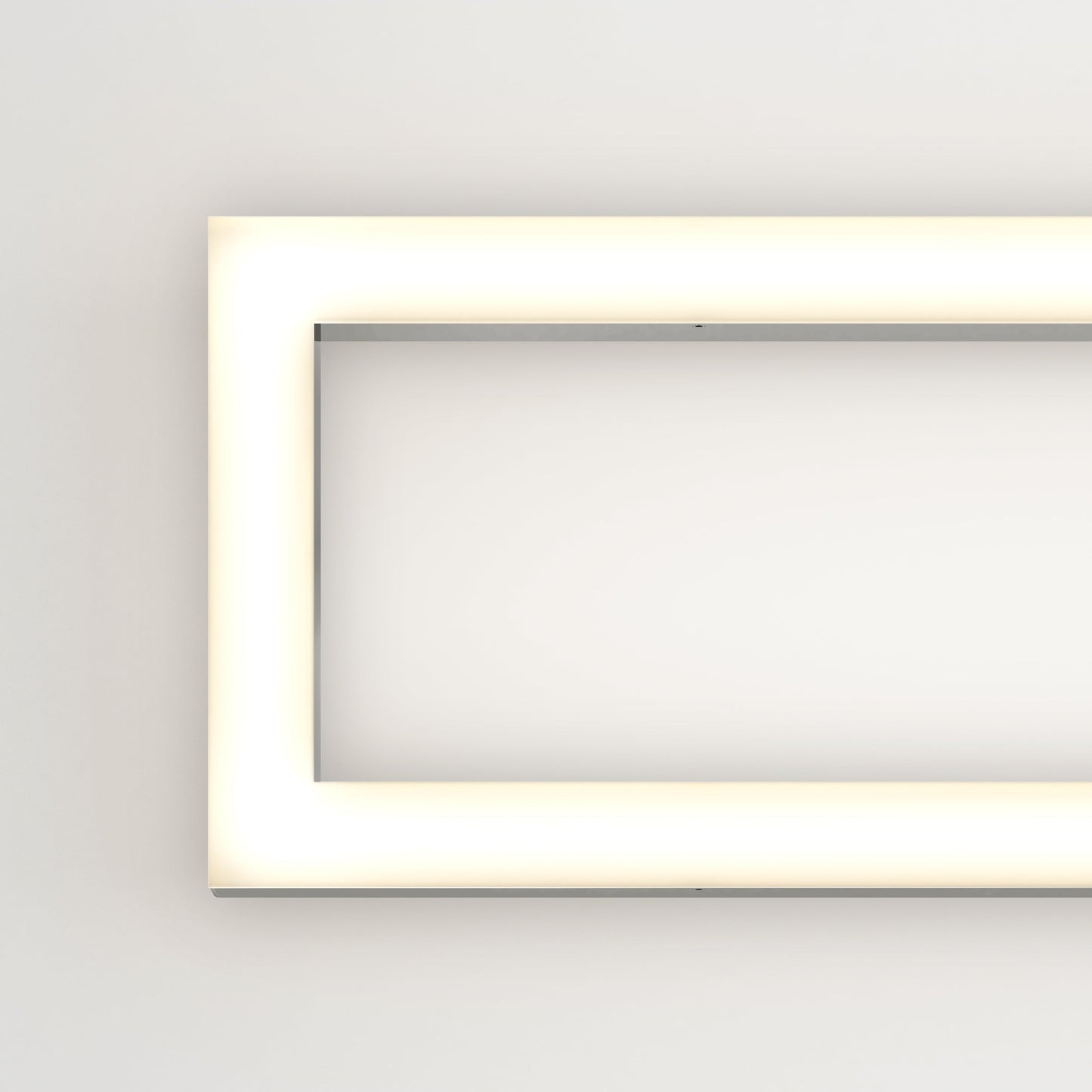 The Artika-CAN-dev Dover modern LED bathroom vanity light 5 CCT is a minimalistic, illuminated rectangular fixture with rounded corners, mounted on a white wall and emitting a soft, even white glow around its edges.