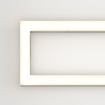 The Artika-CAN-dev Dover modern LED bathroom vanity light 5 CCT is a minimalistic, illuminated rectangular fixture with rounded corners, mounted on a white wall and emitting a soft, even white glow around its edges.