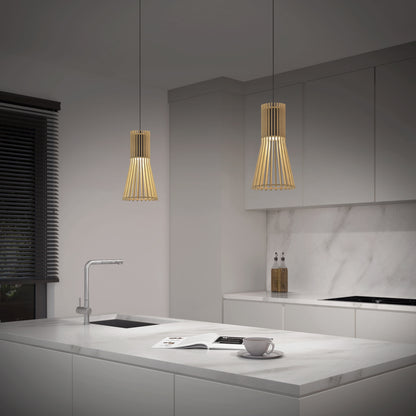 Modern kitchen with white marble countertops, minimalist cabinetry, a sink, cup and magazine on the counter, and a window with black blinds. The space is softly lit by Artika’s Kiyo modern LED pendant 3 CCT lights.