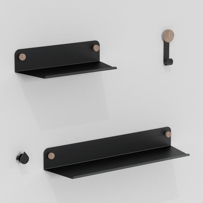 The Artika Sonokit set includes two minimalist black metal shelves and two hooks with wooden accents for Sonolok and Sonofold wall panels, offering quick installation and sleek design ideal for any modern space.