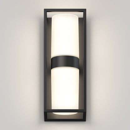 The Artika Sherman modern LED indoor-outdoor wall light 5 CCT features a rectangular black frame and cylindrical frosted glass shade, mounted vertically on a light gray wall for soft, even illumination.