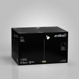 A black box with Artika branding displays an image of a floor lamp called Alton. The lamp has a round base, a slim pole, and a tilted white lampshade, with product details and specifications printed on the box.