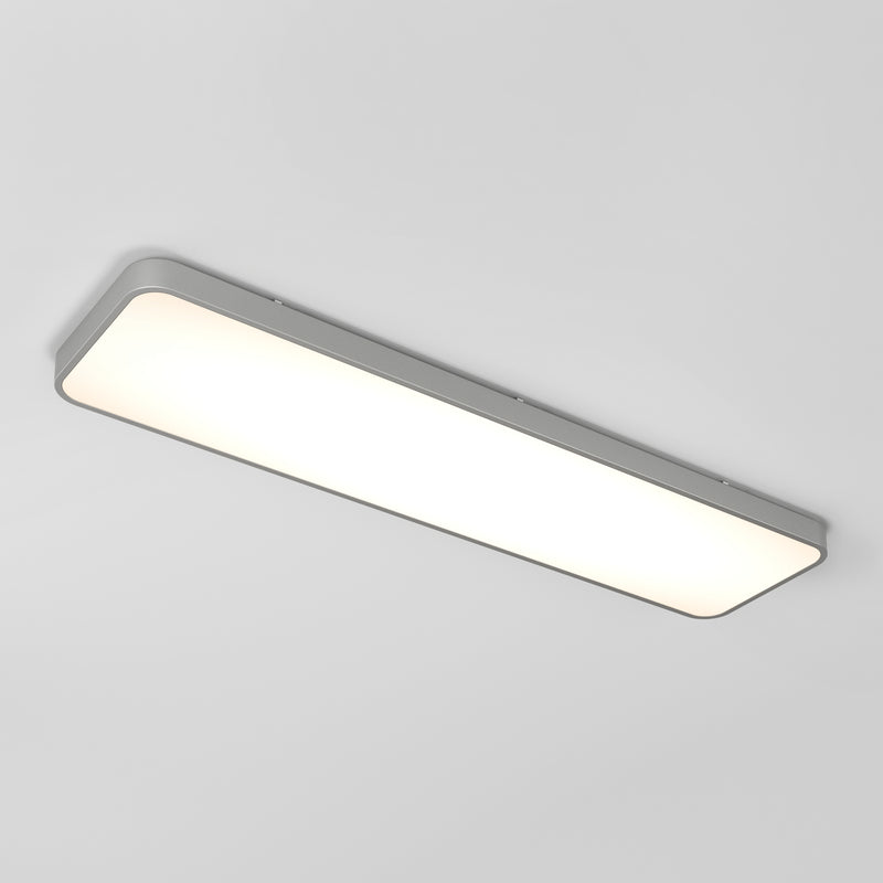 The Artika Europa 48 LED flush mount light features a rectangular white illuminated panel with a slim silver frame, mounted on a plain white ceiling. Includes remote.