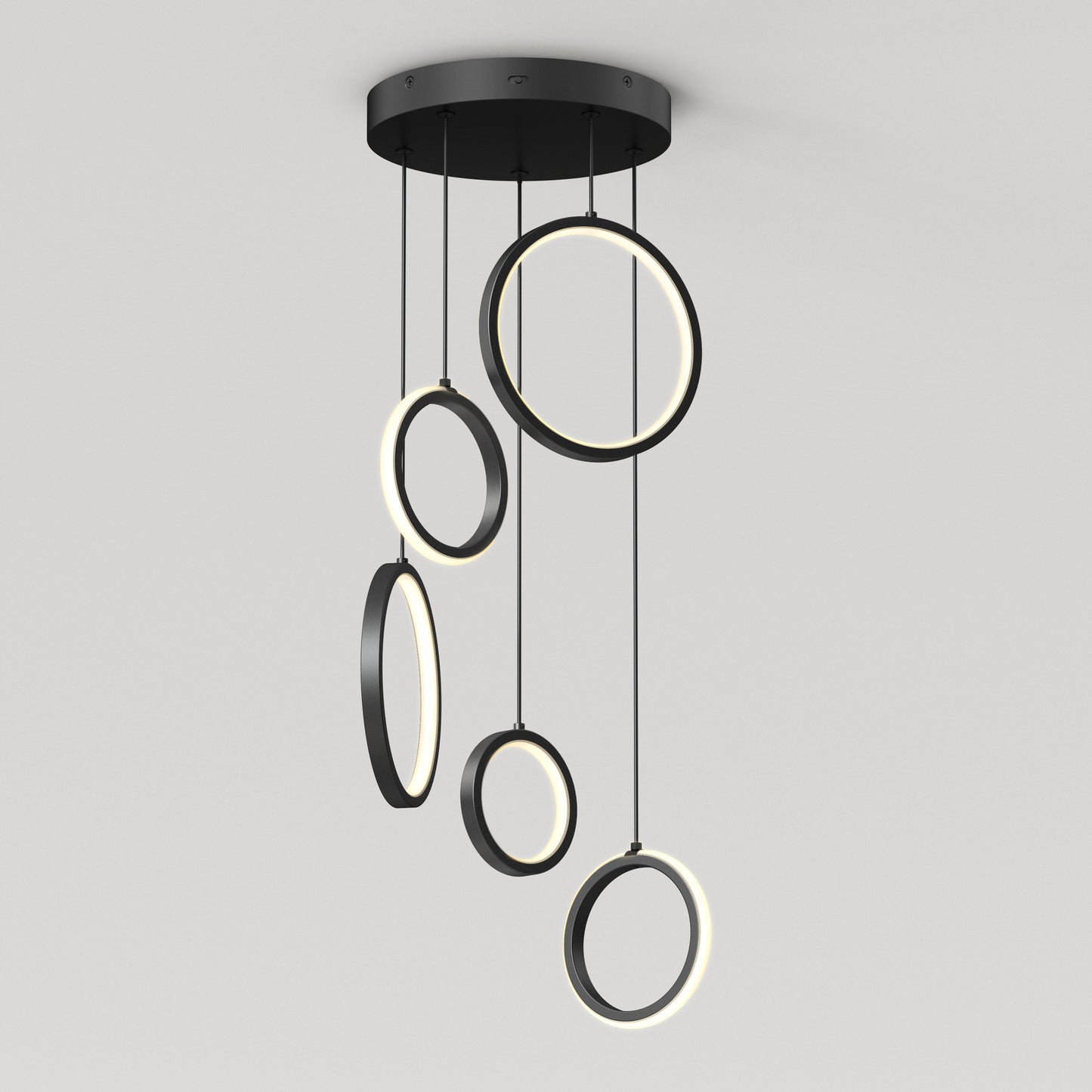 The Artika Elmo 5-light LED pendant features five black rings in varying sizes, each suspended at different heights with built-in LED lights along their inner edges. Adjustable CCT offers versatile modern lighting for any space.