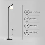 Minimalist black floor lamp with a round white bulb is plugged into a wall. Text highlights features: LED integrated, dimmable, 5000 hours lifespan, and 600 lumens brightness. Simple, modern background.