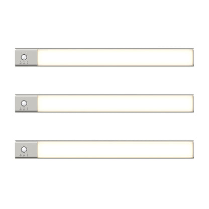 Three slim, rectangular Outline under cabinet LED light 3CCT bars by Artika, featuring silver ends and small control buttons, are arranged horizontally and evenly spaced against a white background.