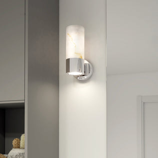 The Artika Marble LED contemporary sconce 5 CCT features a sleek design with a chrome base and frosted cylindrical shade, mounted on a white wall for a modern touch.