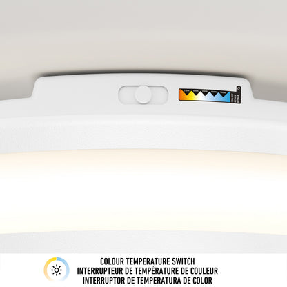 Close-up of the color temperature slider on Artika's Hemisphere 15 in. LED flush mount light, showing five CCT ranges with colored triangles and a COLOUR TEMPERATURE SWITCH label in three languages.