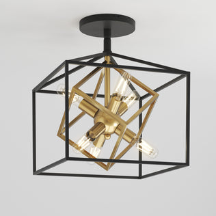 The Artika Imperium flush mount light features a black geometric metal cube frame with a gold interior holding four exposed bulbs, all mounted on a white ceiling.