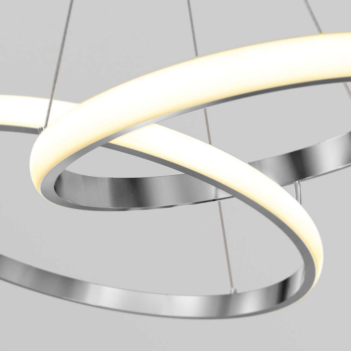 Artika Mora 28″ LED Pendant, 5CCT: Dimmable, modern chandelier with intertwined silver rings, suspended by thin wires.