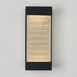 A rectangular wall sconce light fixture with a frosted glass center, featuring horizontal lines and black borders on the top and bottom, mounted on a white wall.