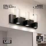 A modern matte black LED wall light with three rectangular fixtures is mounted above a bathroom mirror. Text highlights its steel finish, energy efficiency, integrated LED, and a 3-year warranty.
