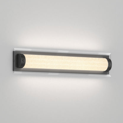 The Artika Glamour LED bathroom vanity light 3 CCT features a modern wall-mounted design with rectangular frosted glass and black metal ends, casting a soft, even glow against a light gray wall.