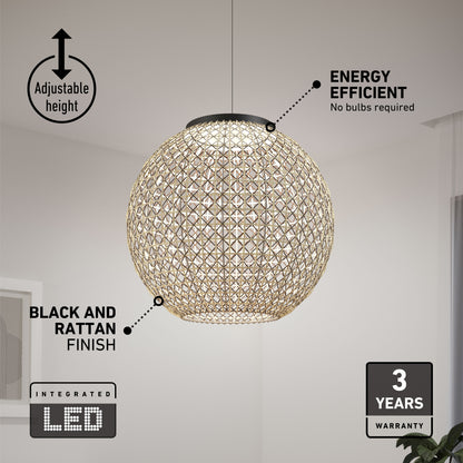 The Artika Benson LED pendant light 5 CCT hangs from the ceiling, featuring integrated LED, adjustable height, and a black and rattan finish. Labels show its energy efficiency and 3-year warranty. A picture frame is partly visible on the wall.